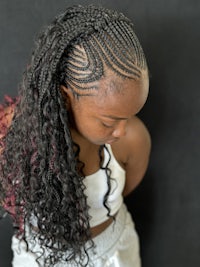 a young girl with braids in her hair